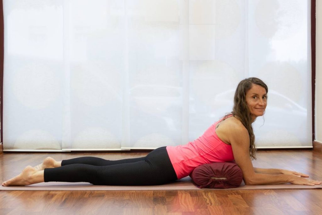 salamba bhujangasana sphinx pose with bolster.