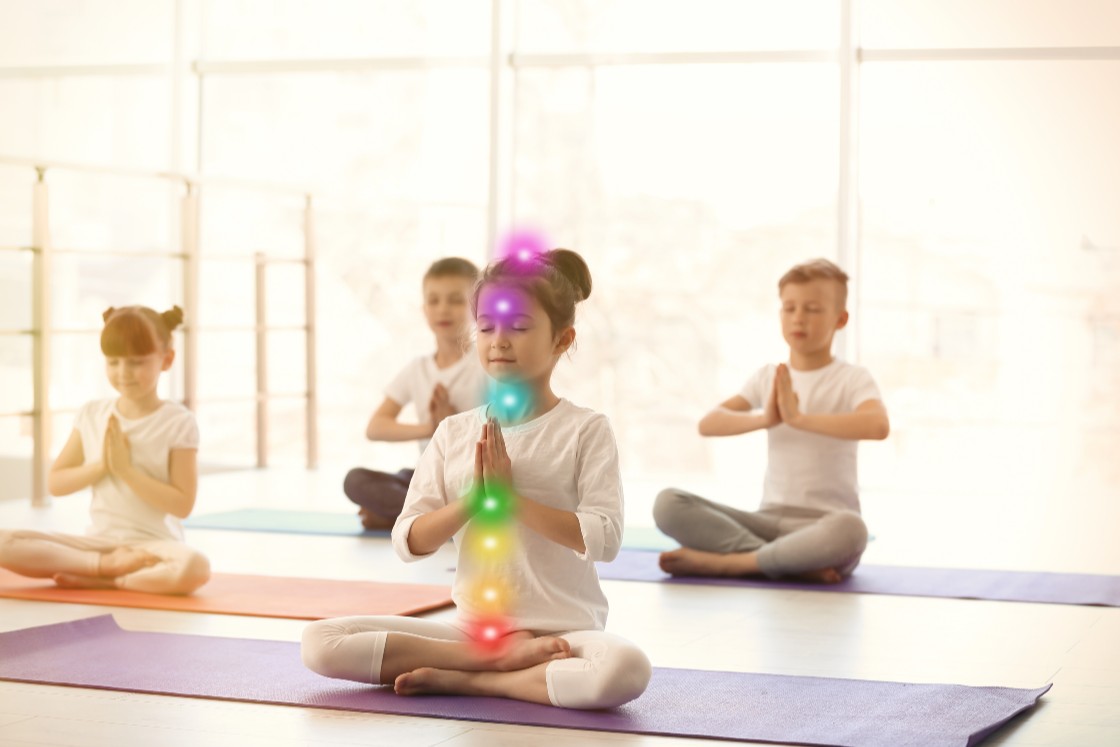 children practicing kundalini yoga in white clothes