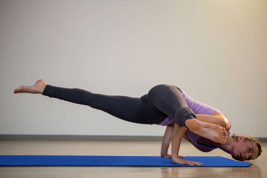 Premium Photo | Woman yogi with dreadlocks doing eka pada koundinyasana  balance on arms pose of yoga