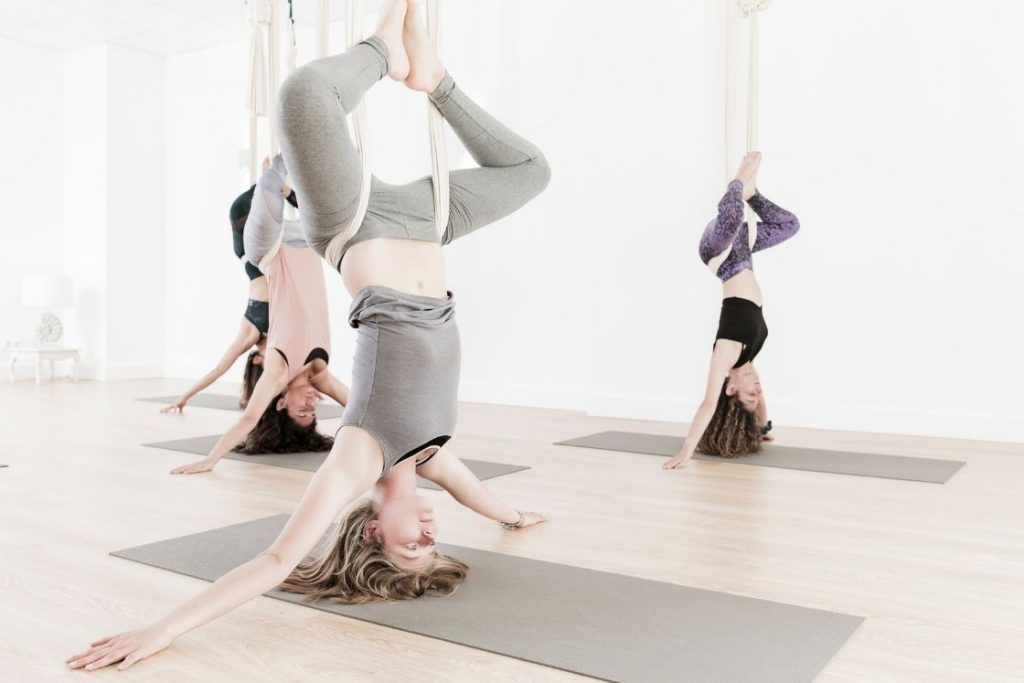 Aerial Yoga for Beginners: Benefits and Tips - CalorieBee
