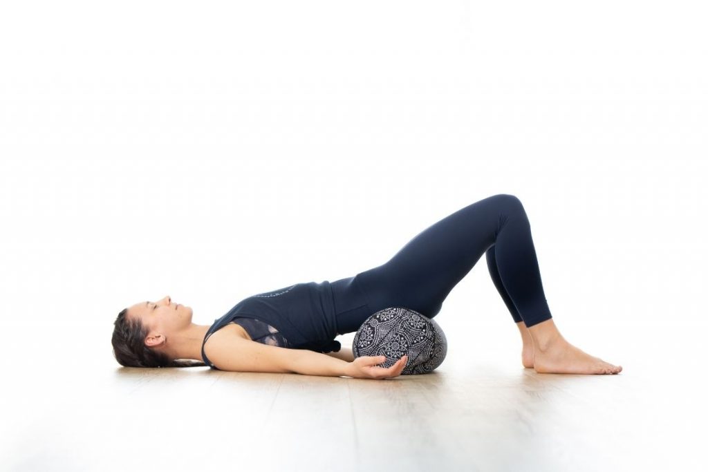 Yoga for Fertility: Supported Bridge Pose - Yoga Goddess