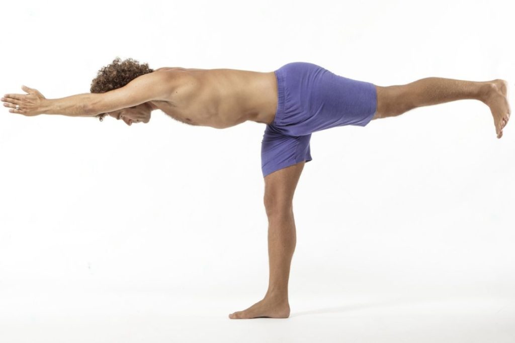 Premium Photo | Sporty man doing standing forward bend posture. guy  practicing yoga, stand head to knees at gym, copy space